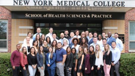 D.P.T. Class of 2023 Doctoral Project Presentation participants in front of the School of Health Sciences and Practice