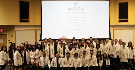 D.P.T. Class of 2025 White Coat recipients with faculty and SHSP leadership