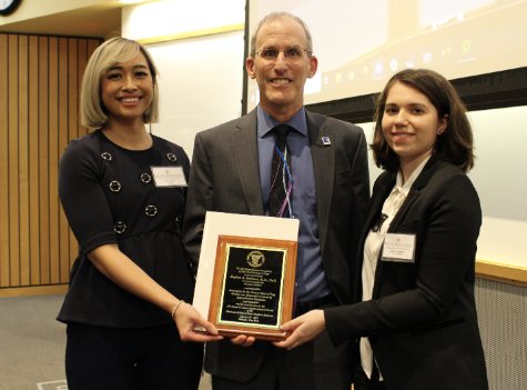 Stephen R. Hammes, M.D., Ph.D being awarded a commemorative plaque at the 33rd Annual Graduate Student Research Forum 