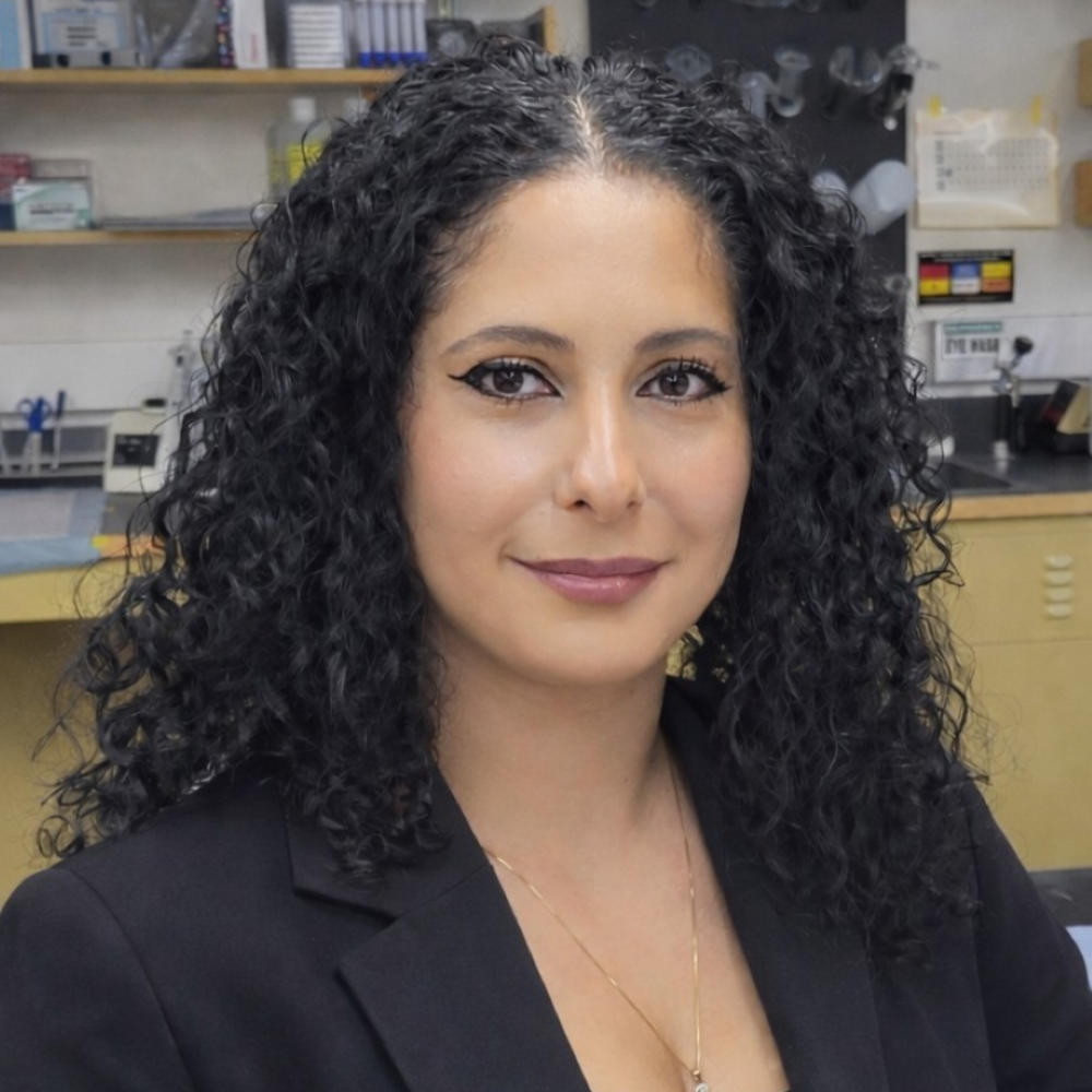 woman with long dark curly hair wearing black jacket