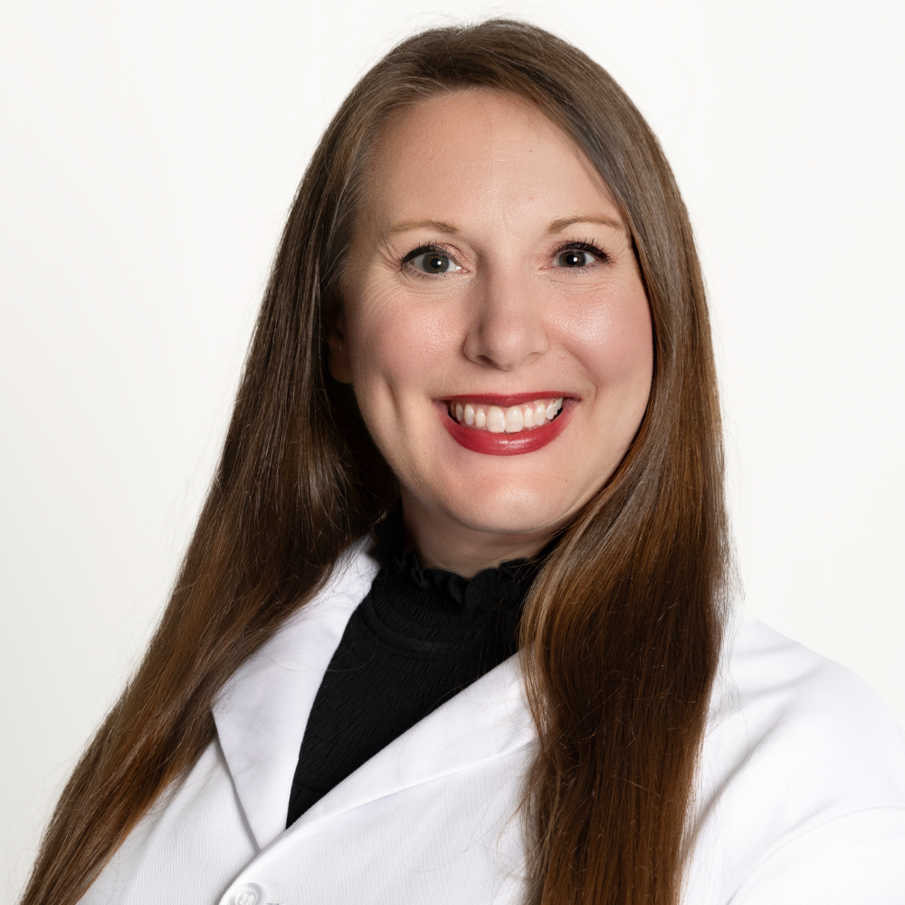 woman with long brown hair wearing white coat