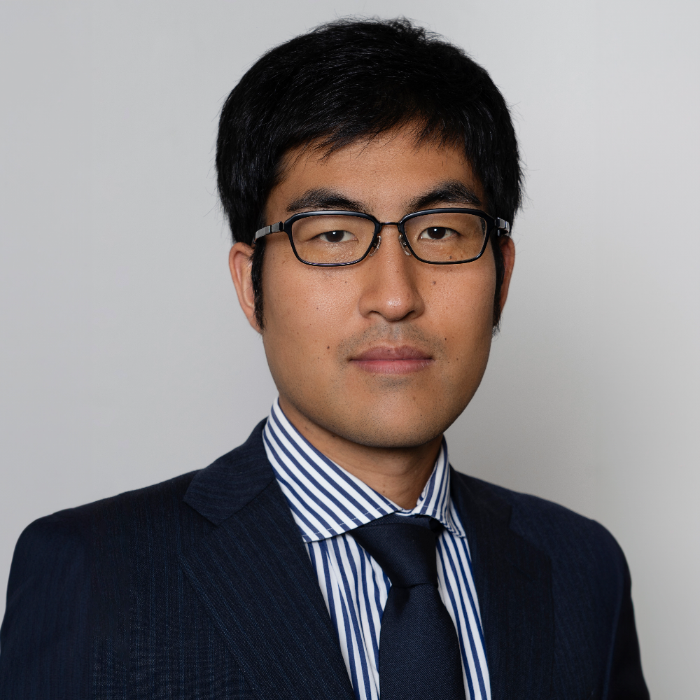 asian man with glasses wearing blue suit with blue striped shirt and tie