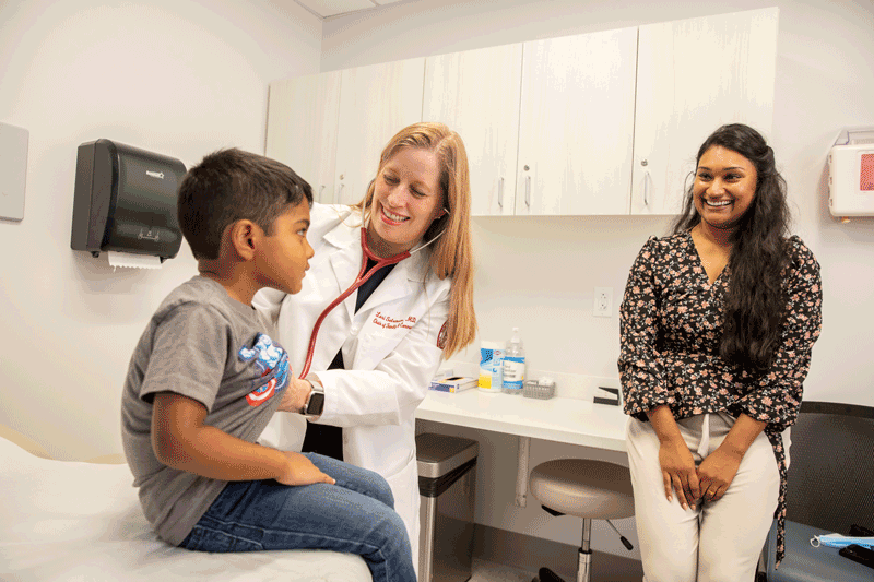 Lori A. Weir Solomon, M.D. '99, M.P.H. '09, with pediatric patient at the Family Health Center.