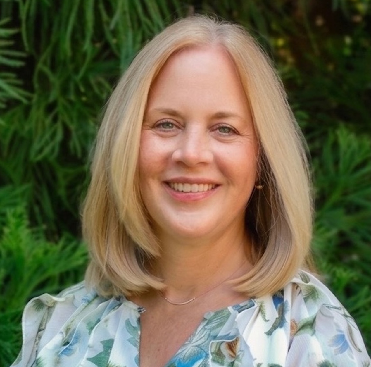 Woman with short blond hair smiling