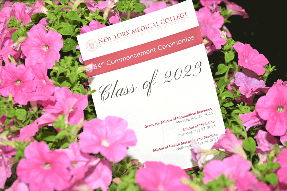 NYMC Commencement 2023 program on pink flowers.