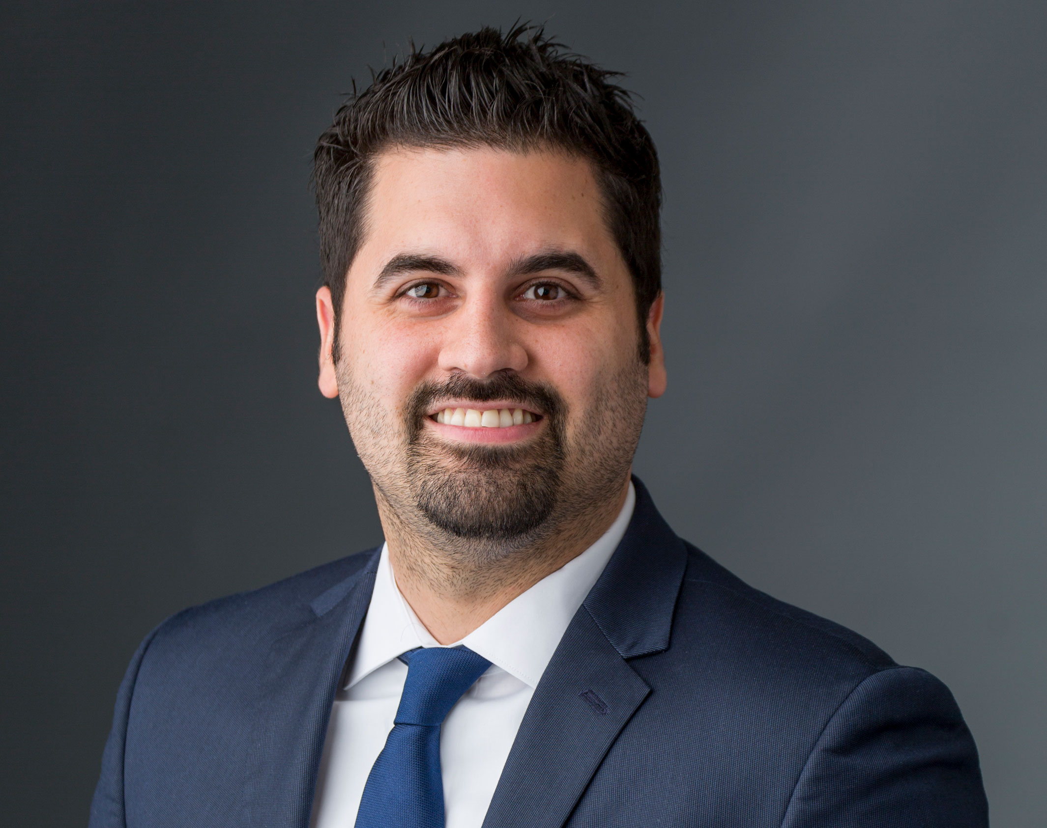 Dr. Victor Garcia in a suit and tie smiling.