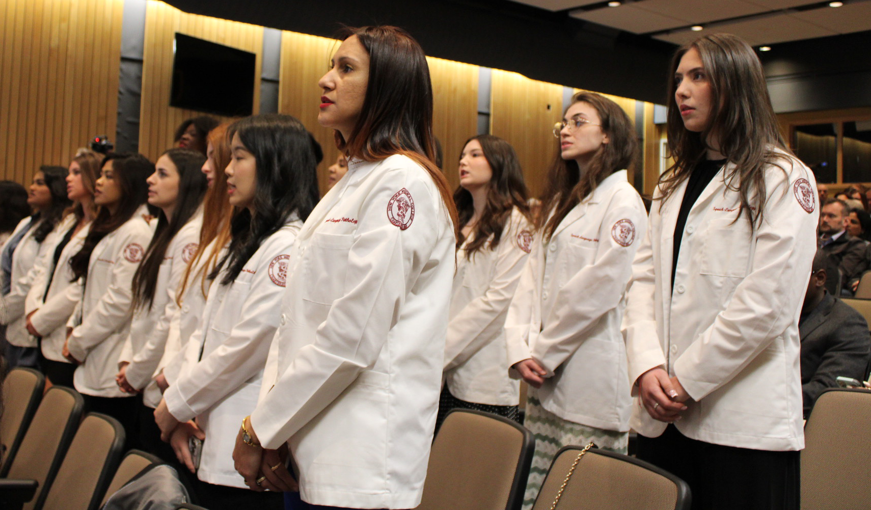 Speech-language pathology students reciting their pledge at the White Coat Ceremony.