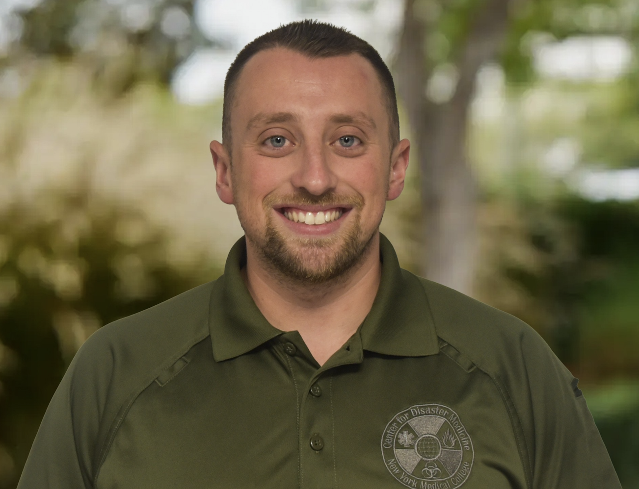 Man smiling in green shirt