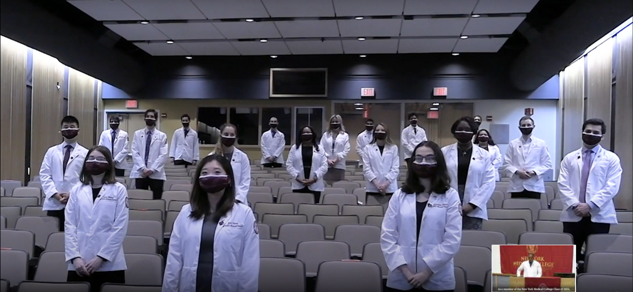 SOM Class of 2024 students donning their white coats for the first time.