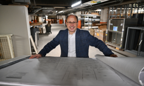 Man standing in front of table smiling