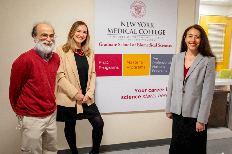 Drs. Holz, Cheairs and Lerea standing in front of the new GSBMS sign