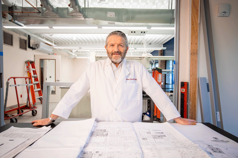 Dr. Amar in research lab smiling