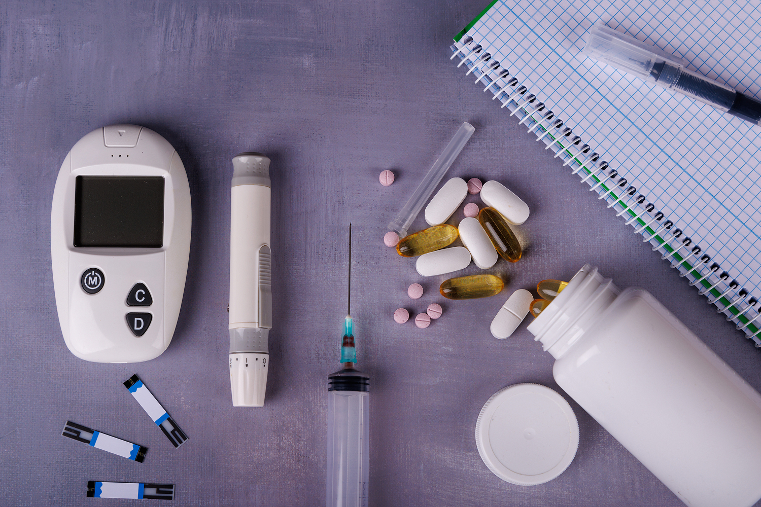 Table with diabetic supplies and pills