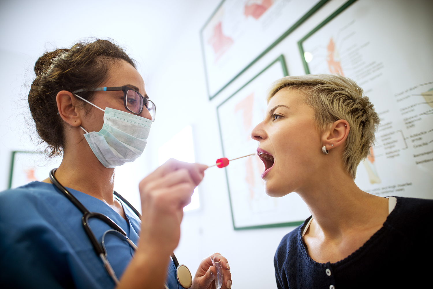 Doctor taking swab of patient's mouth