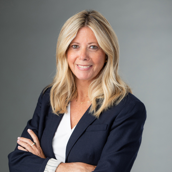 Woman in navy blazer posing for headshot
