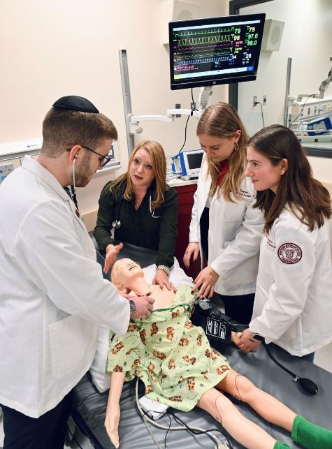 Students work with SimsJunior manikin