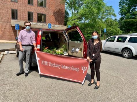 Sean Lynch and Sivan Shahar holding banner reading: "NYMC Psychiatry Interest Group"