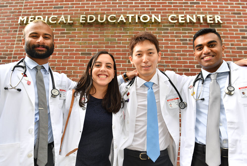 Four School of Medicine Class of 2025 Students with their White Coats