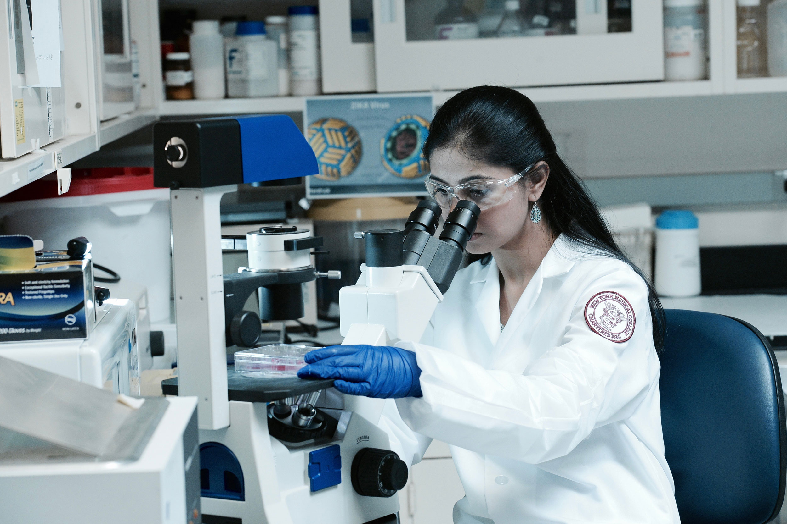 female student using microscope in lab